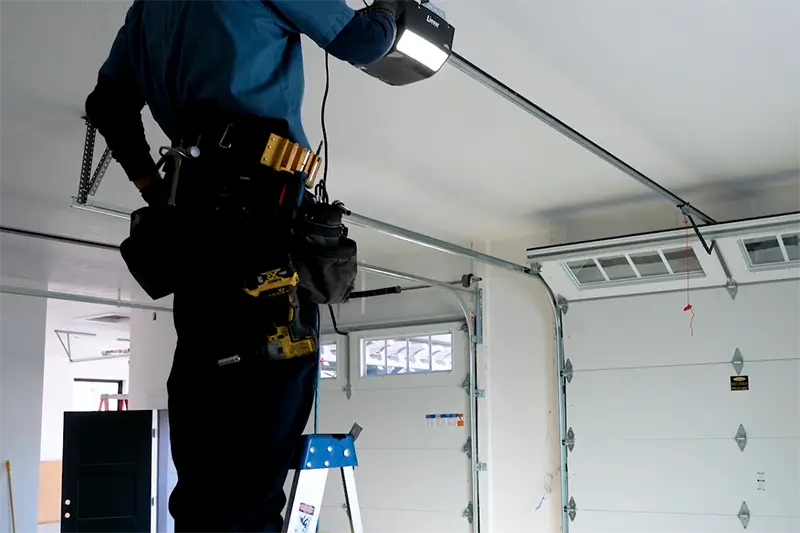 A technician doing a garage door opener installation