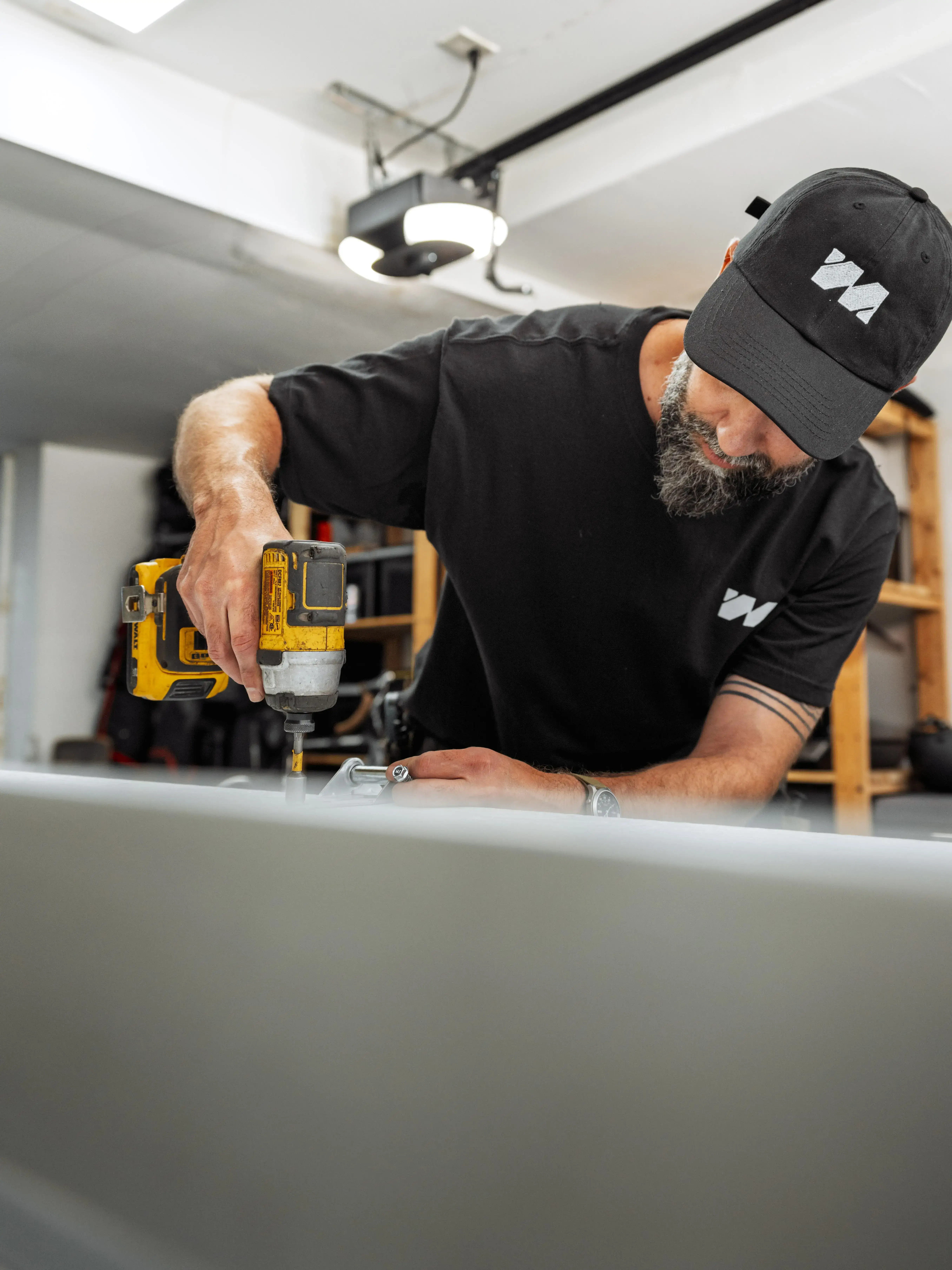 Local Technician doing a garage door repair in a garage door panel